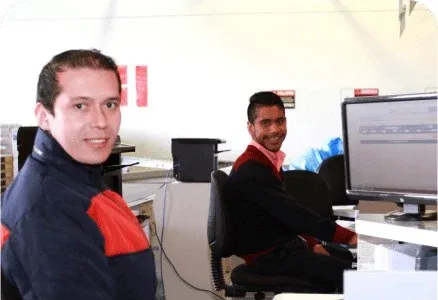 Dos integrantes del equipo de Deprisa trabajando con computadores.